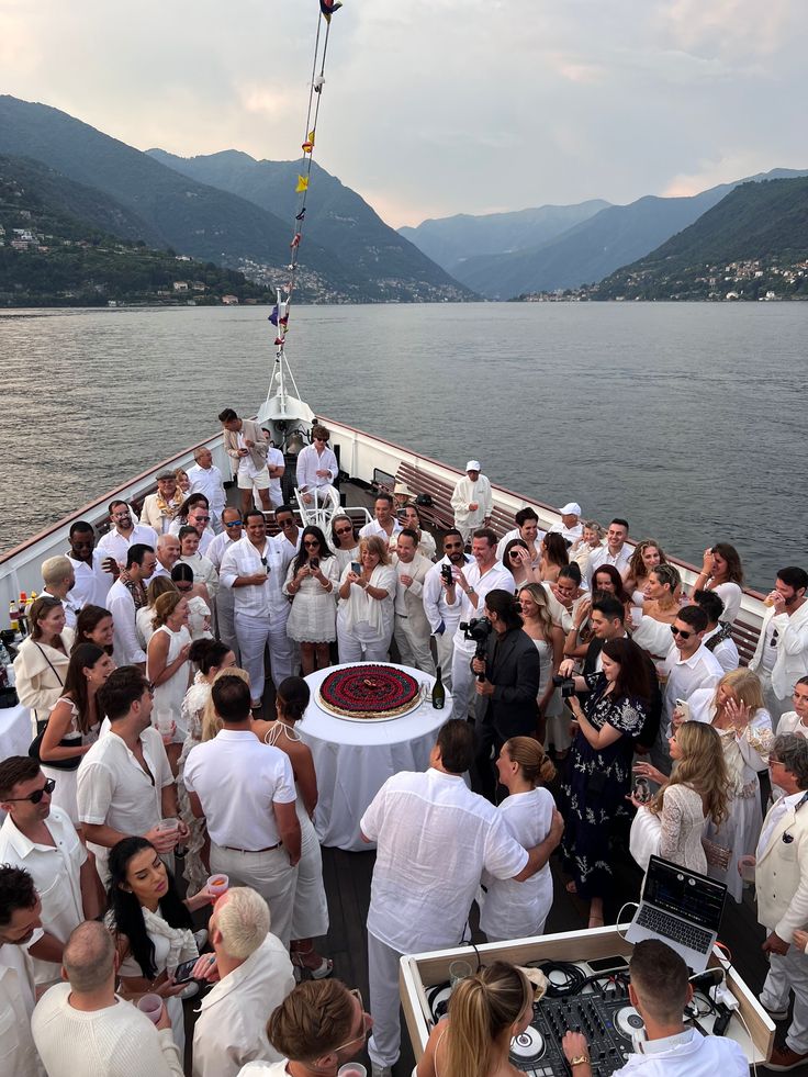 a large group of people standing on top of a boat