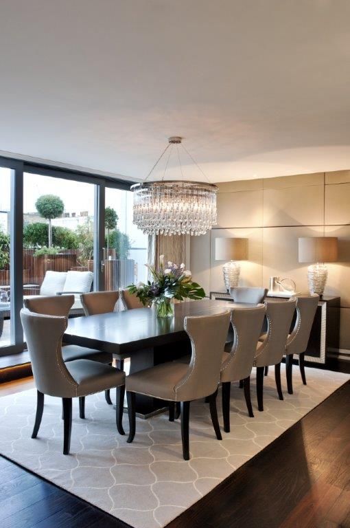 a dining room table with chairs and a chandelier