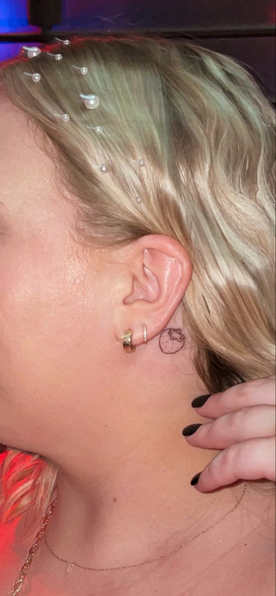 a woman with blonde hair and piercings on her ear