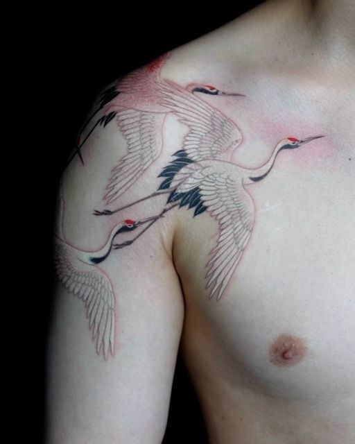 a man's chest with two birds on it and one bird flying in the air