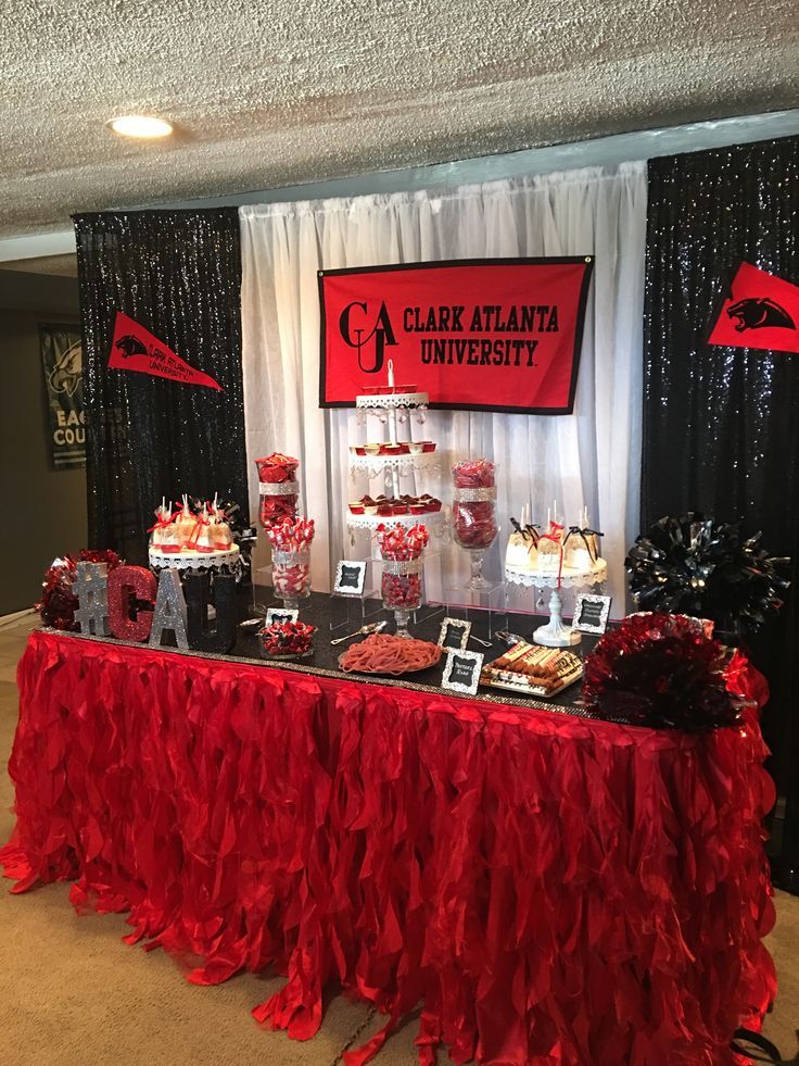 the dessert table is decorated with red and black decorations