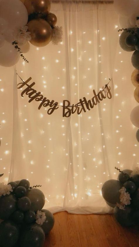 a birthday backdrop with balloons and lights