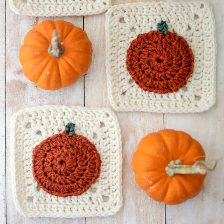 four crocheted pumpkins and two small pumpkins