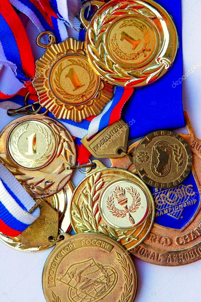 several medals are placed on top of each other