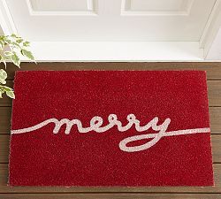 a red door mat with the word merry written in white on it next to a potted plant