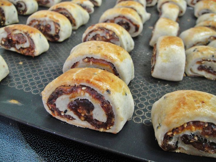 several pastries on a baking sheet ready to be baked in the oven or used as an appetizer