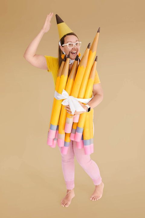 a woman in a costume made out of pencils is holding her arms up to the side