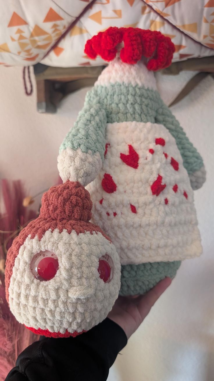 two crocheted stuffed animals sitting next to each other