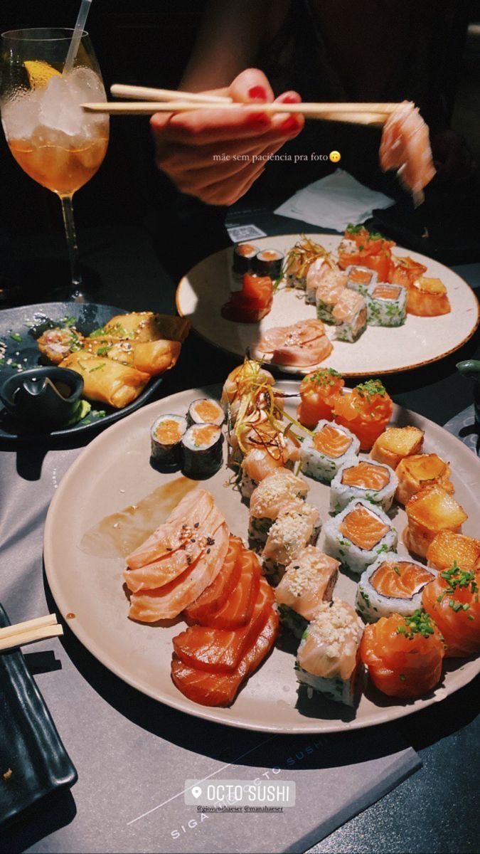 sushi platter with chopsticks and wine on table