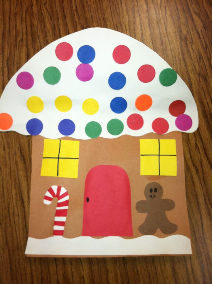 a paper plate with a house made out of polka dots and candy canes on it