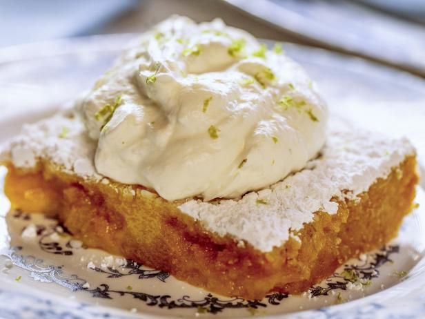 a piece of cake topped with whipped cream on top of a white and blue plate