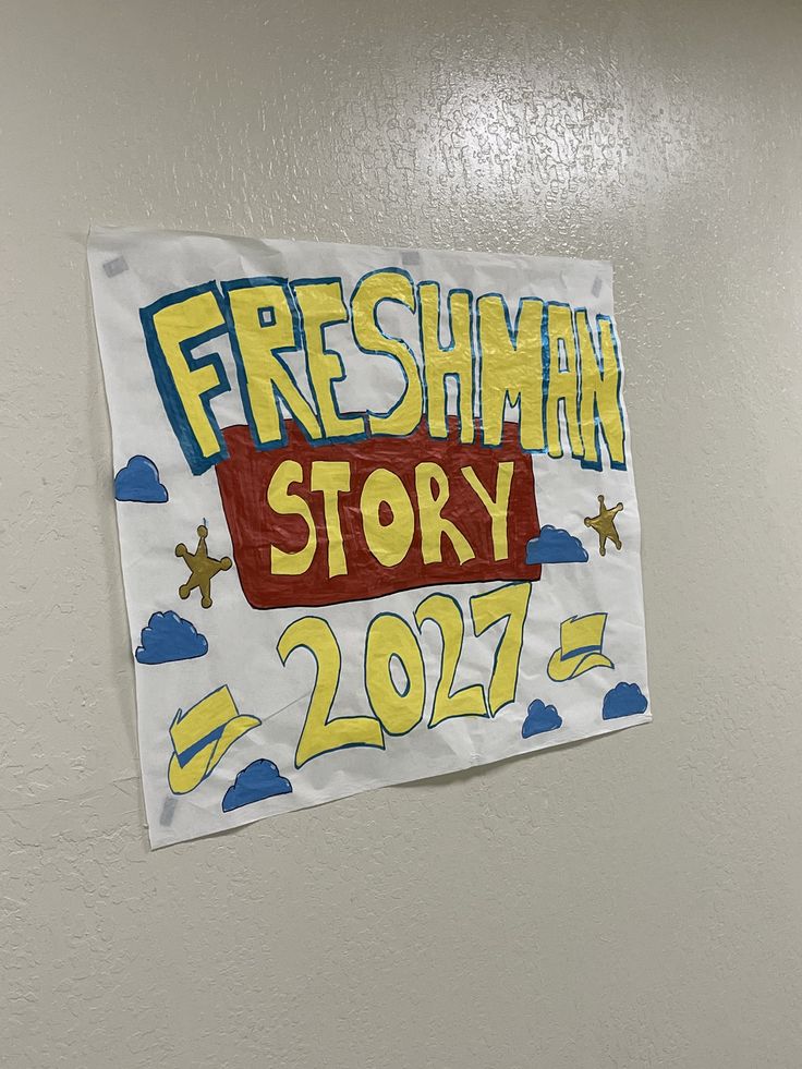 a sign hanging on the side of a wall that reads, freshman story 2017