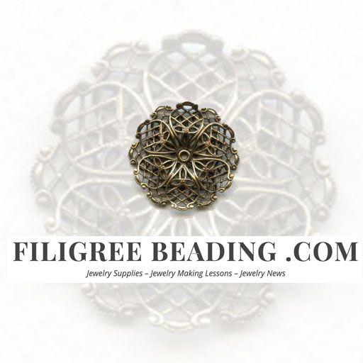 an image of a brooch with filigree beading on it