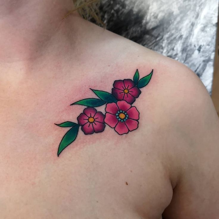 a woman's chest with pink flowers on it