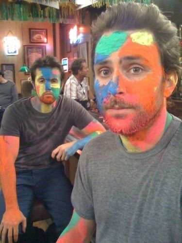 two men with their faces painted in different colors