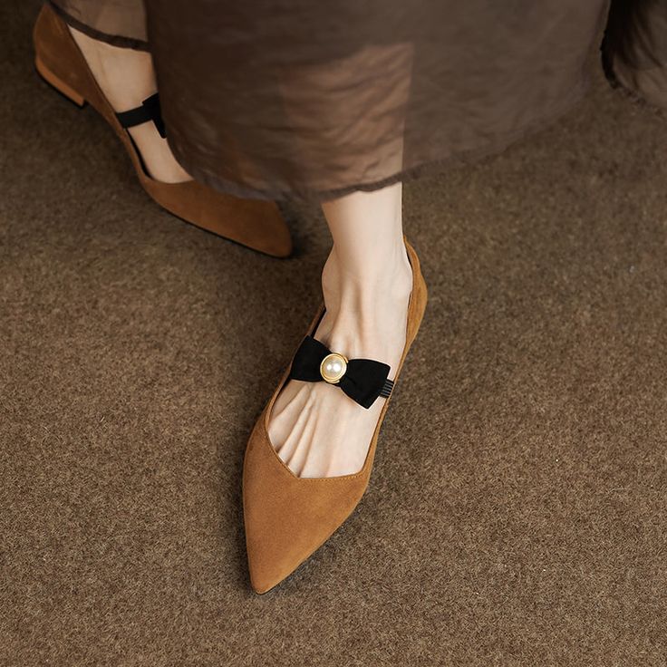 Looking for a stylish and elegant way to add a touch of femininity to your everyday look? Check out our pointed toe flats! These beautiful shoes feature a dainty bow and pearl embellishment. and are crafted from luxurious suede. They're perfect for desk-to-dinner days or any time you want to feel put-together and chic. Upper: Suede Lining: Leather Outsole: TPR Toe: Pointed Toe Heel: 2cm Closure: Slip on Color: Brown. Black is_handmade: Yes The above measurement is based on size 6. with one size Elegant Pointed Toe Ballet Flats For Party, Elegant Party Ballet Flats With Pointed Toe, Elegant Pointed Toe Flats With Bow For Party, Feminine Pointed Toe Ballet Flats For Party, Elegant Pointed Toe Flats With Bow For Summer, Elegant Pointed Toe Flats With Bow For Evening, Elegant Pointed Toe Flats With Flat Heel For Summer, Elegant Summer Pointed Toe Flats With Flat Heel, Elegant Summer Pointed Toe Flats With Bow