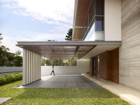 a person walking on the grass in front of a building