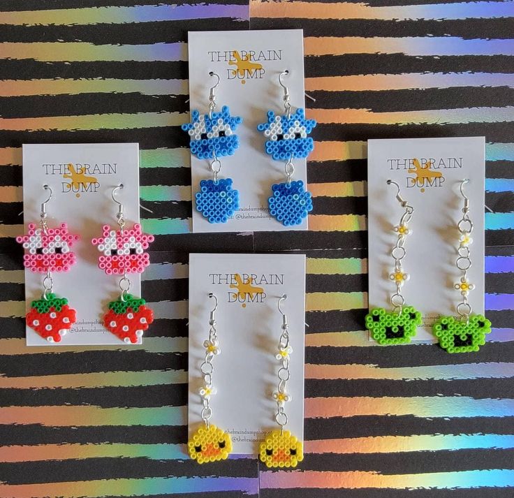 three pairs of earrings made out of perler beads and bead with charms attached to them