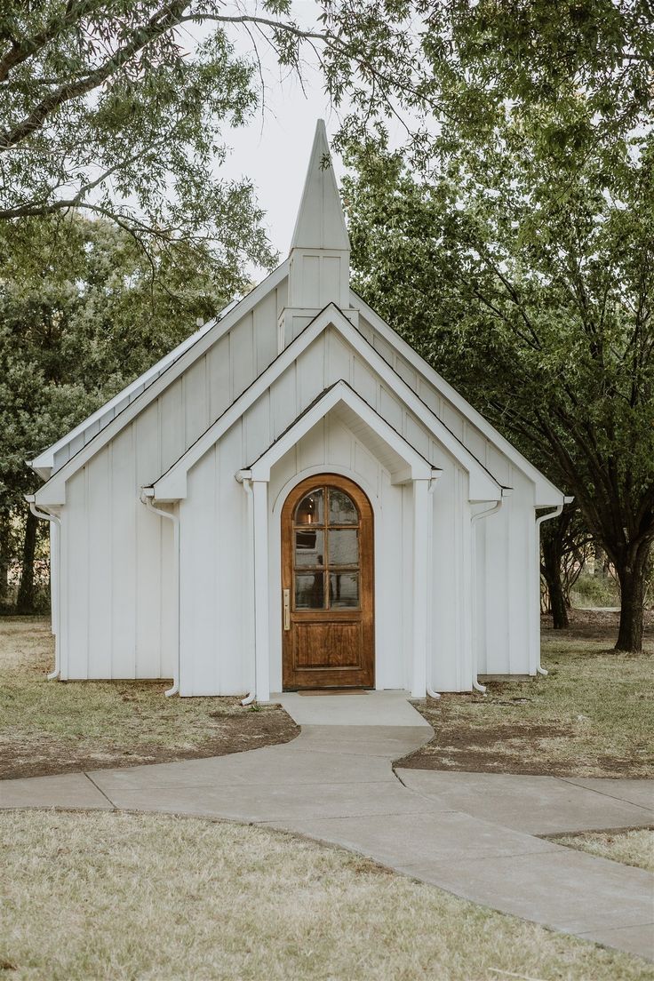 a small white church with a wooden door