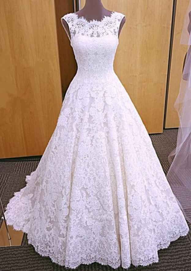 a white wedding dress on display in front of a wooden door