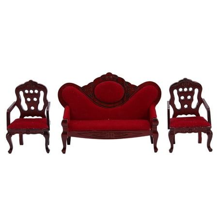 a red couch and two chairs sitting next to each other