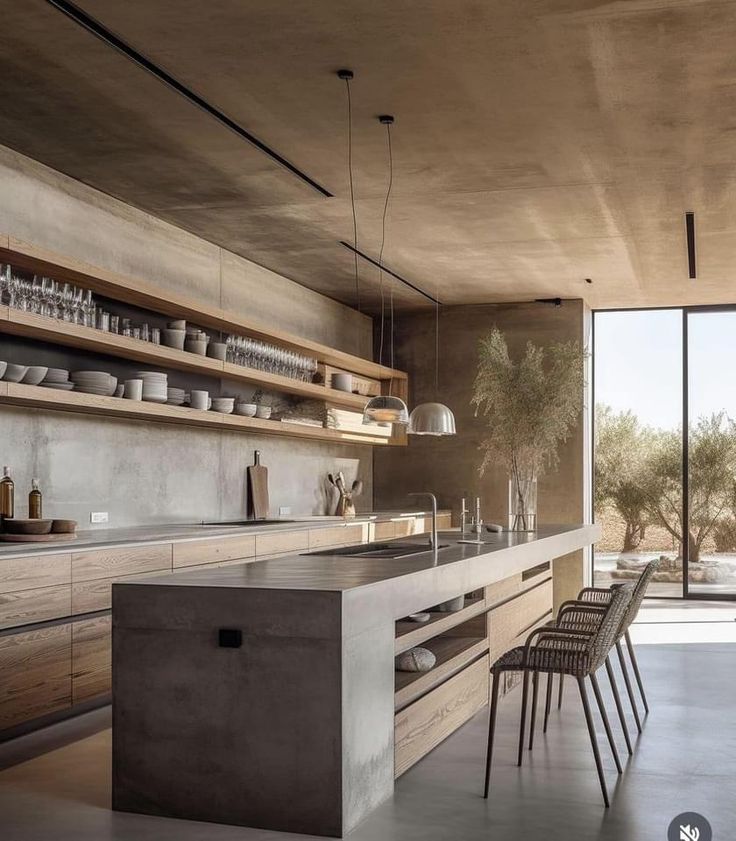 an open kitchen with lots of counter space and wooden shelves on the wall next to it