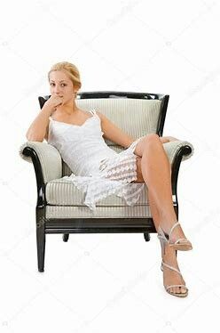 a woman sitting in a chair with her legs crossed