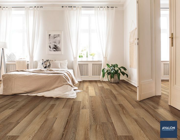 a bedroom with wood floors and white walls