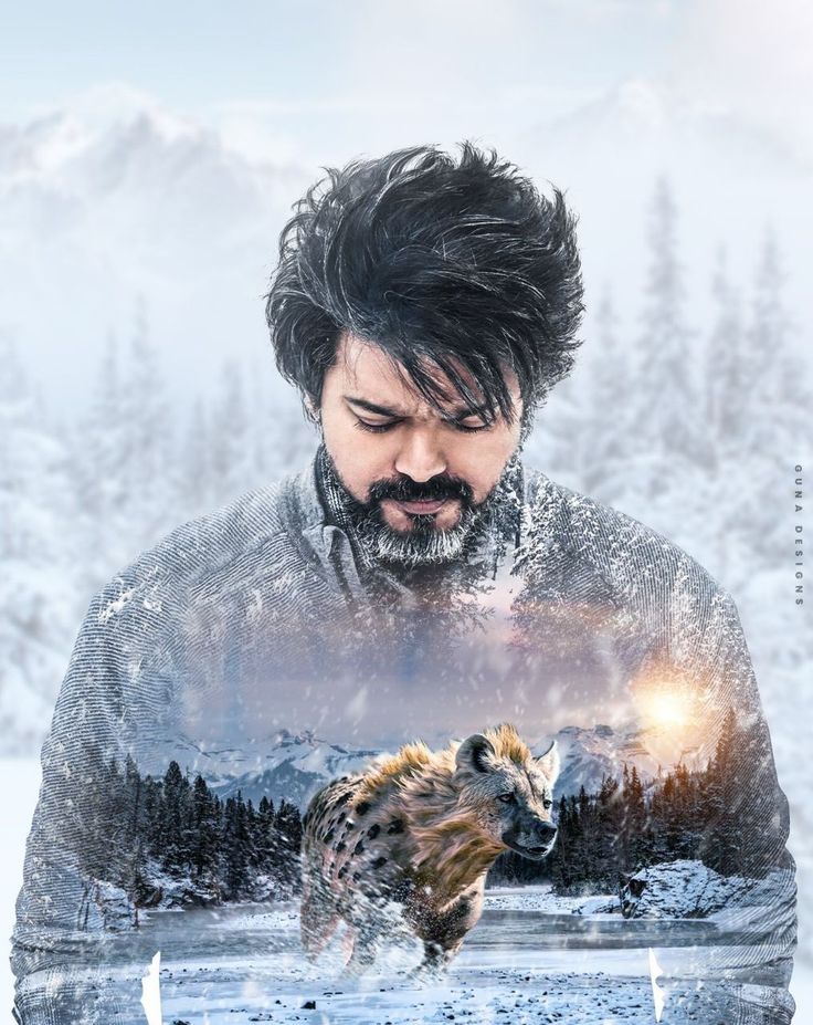 a man with a beard standing in the snow next to a hyena