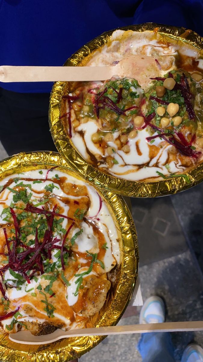 two golden bowls filled with different types of food