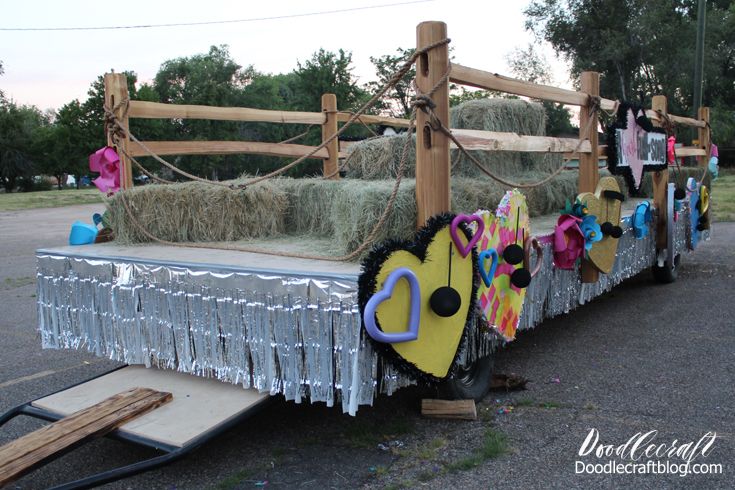 a trailer with hay bales and decorations on it