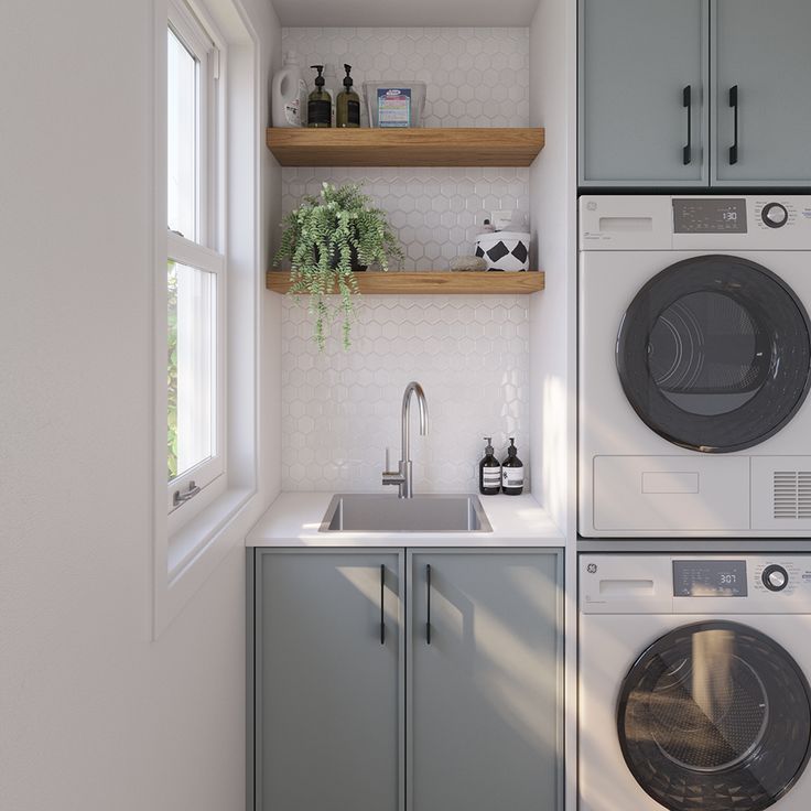 a washer and dryer in a small room next to a window with open shelves