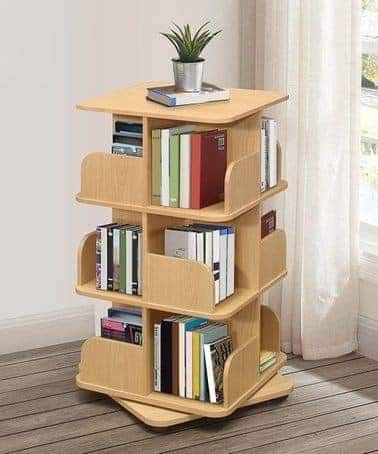 a book shelf with books and a plant on top