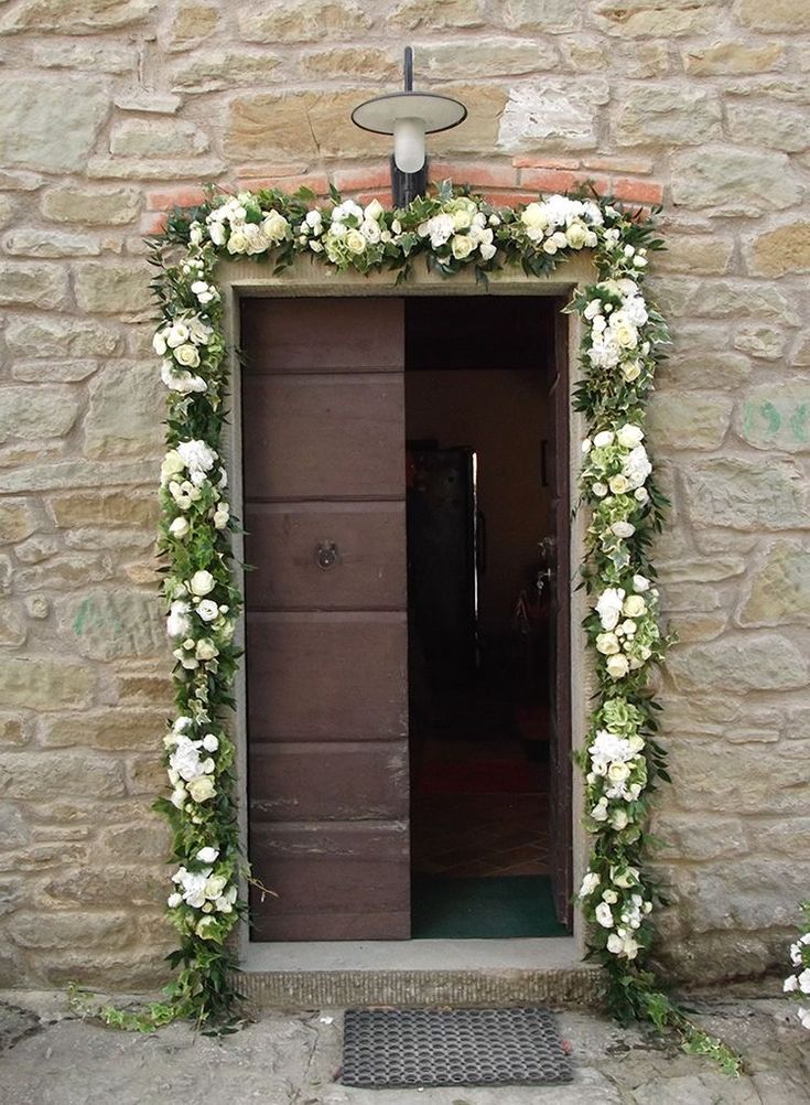 an entrance to a building with flowers on it