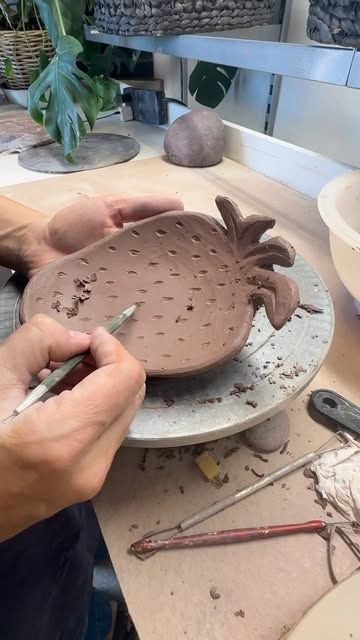 a person is working on a clay sculpture