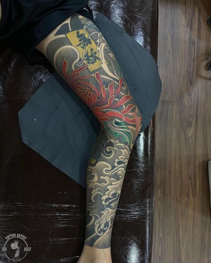 a person with tattoos on their legs and leg