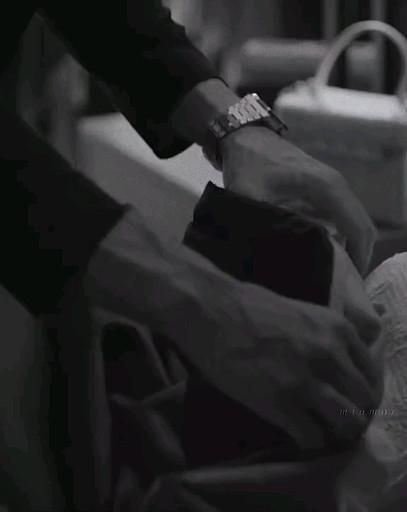 a woman is getting her nails done at the hairdresser's salon in black and white