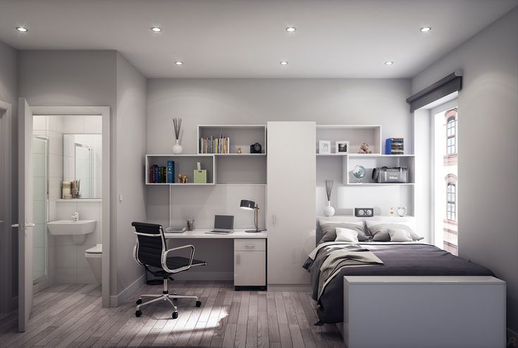 a bedroom with a bed, desk and chair in it next to a book shelf