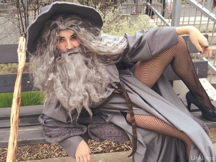 a man dressed as an old wizard sitting on a bench