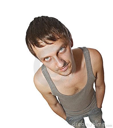 a young man in grey tank top looking at the camera with an angry look on his face