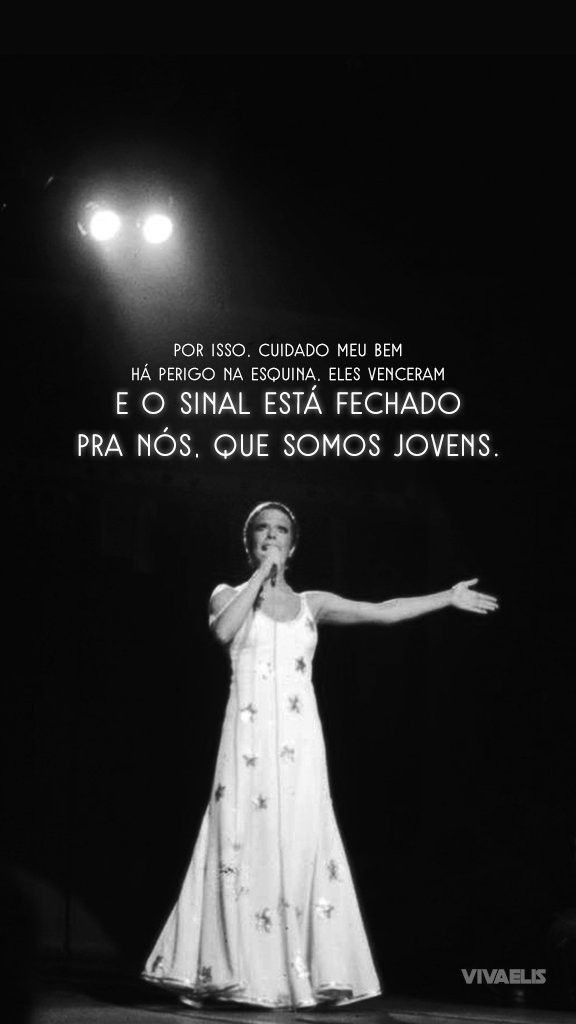 a black and white photo of a woman in a dress on stage with her arms outstretched