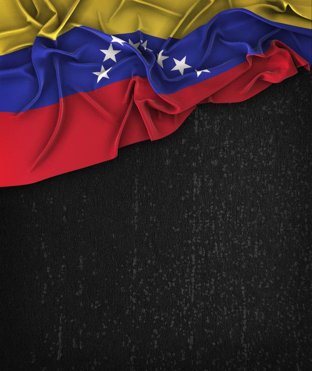 the flag of venezuela is waving in the wind on a black textured background with space for text