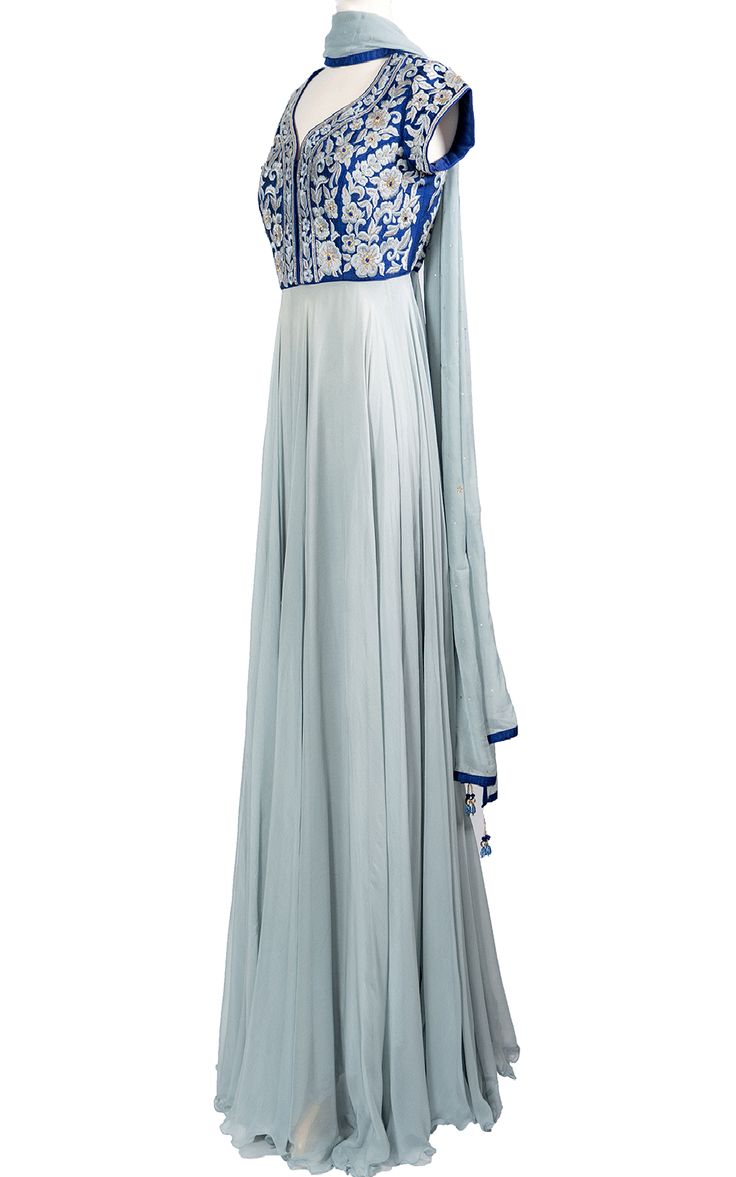 An elegant cool blue chiffon Anarkali drapes beautifully across the body and stands out with a raw silk royal blue top with tonal thread and zari embroidery.Length: 63Fabric: Top - Raw Silk, Gown / Dupatta - ChiffonEmbroidery: Thread, Stone Silk Blue Anarkali Set For Navratri, Blue Georgette Anarkali Set With Cutdana, Elegant Blue Anarkali Set With Cutdana, Blue Silk Churidar For Navratri, Blue Silk Churidar With Chikankari Embroidery, Blue Raw Silk Churidar For Navratri, Blue Anarkali Set With Traditional Drape, Blue Georgette Anarkali Set With Traditional Drape, Blue Anarkali Set With Sheer Dupatta And Traditional Drape