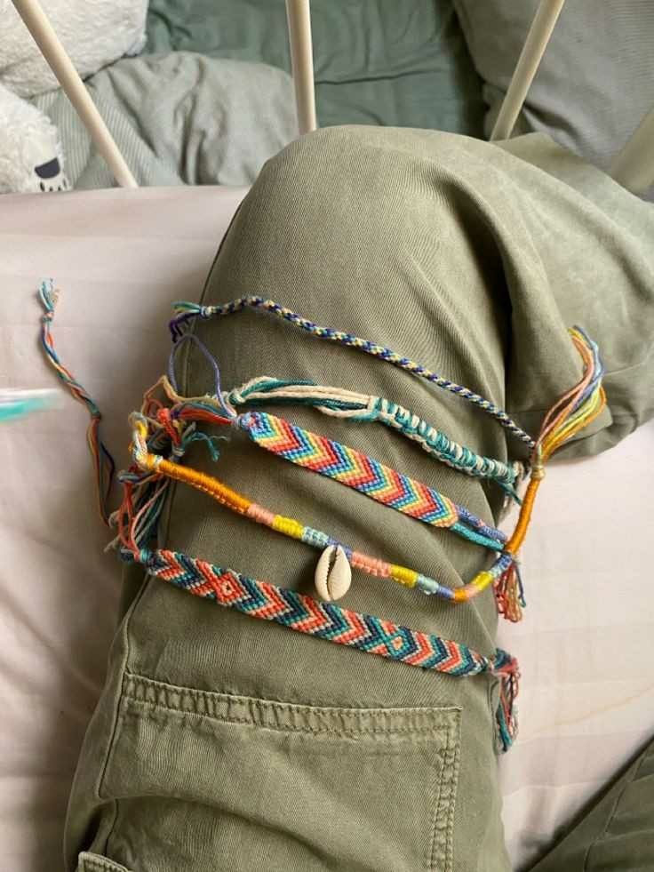 a stuffed animal laying on top of a bed next to some string wrapped around it