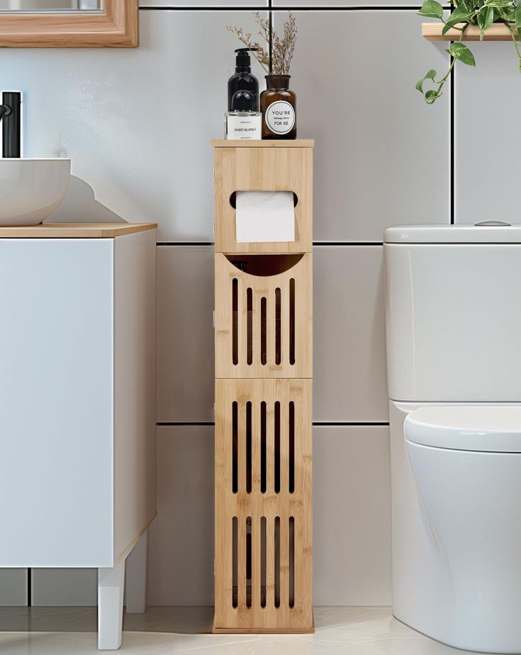 a bathroom with a toilet, sink and wooden shelf next to the toilet paper dispenser