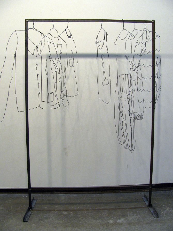 an art piece with clothes hanging on it