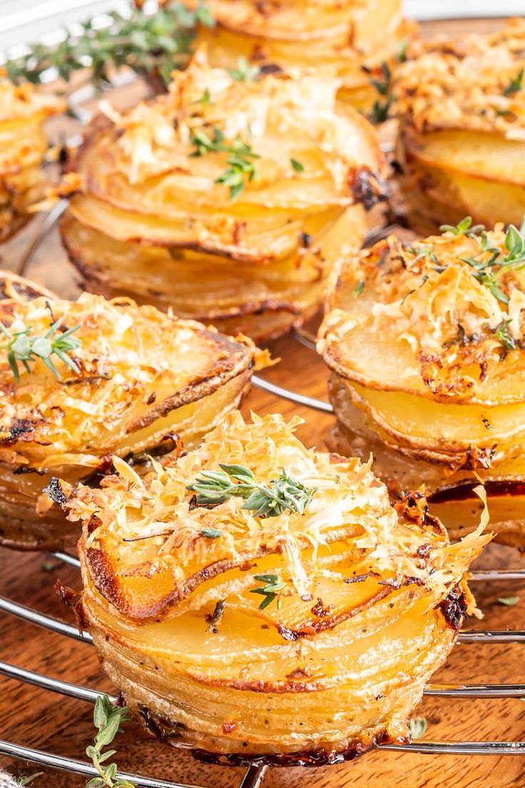 baked potatoes with parmesan cheese and herbs on a cooling rack, ready to be eaten