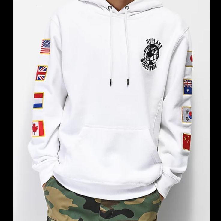 Nwot International Styling Can Be Yours With The Flag White Hoodie From Hypland. Coming With A Fleece Lining For A Comfortable Fit, This Hooded Pullover Sweatshirt Features A "Hypland Worldwide" Logo Graphic Embroidered At The Left Chest And Flag Patches Down Both Sleeves. Price Is Firm! M-01 White Long Sleeve Urban Hoodie, White Fleece Hoodie With Graphic Print, White Fleece Urban Hoodie, Urban Style White Fleece Hoodie, White Urban Fleece Hoodie, White Urban Style Fleece Hoodie, Worldwide Logo, White Flag, Flag Patches