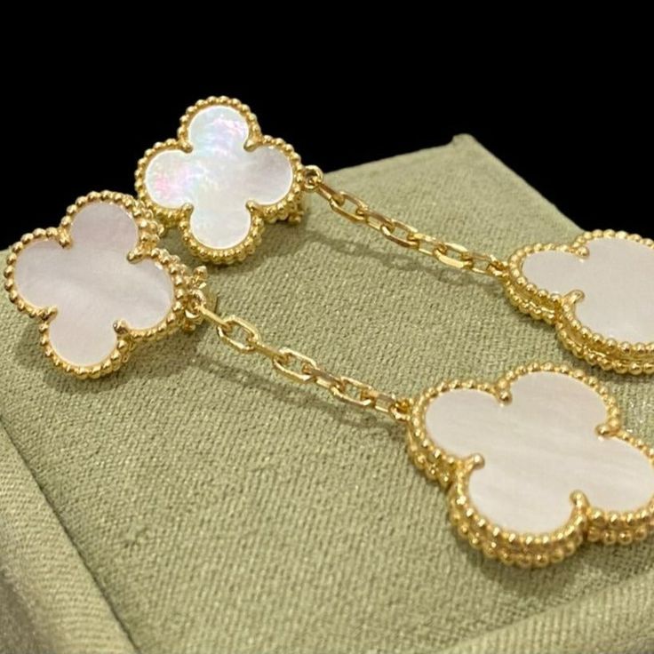 Discover the elegance of these Clover White MOP Earrings. Featuring two intricate motifs, these earrings are expertly crafted to add a touch of sophistication to any outfit. Made with premium materials, they offer timeless beauty and lasting durability. Elevate your style with these stunning earrings. ADDITIONAL INFORMATION Color: Silver Stone: Mother of pearl Ref. VCARO9II00 Material:- 925 Sterling Silver - 18k Gold Plated- 18k Real Gold ( contact us via instagram) Our replica products are comm Luxury 14k Gold Flower-shaped Earrings, Luxury 14k Gold Flower Shaped Earrings, High Quality Gold Jewelry As A Gift, Luxury Dangle Jewelry For Formal Occasions, Luxury Dangle Earrings With Elegant Design, Luxury Gold Flower-shaped Earrings, Luxury White Earrings For Evening, Luxury White Evening Earrings, Luxury Pierced Sterling Silver Jewelry