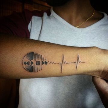 a man with a heartbeat tattoo on his arm